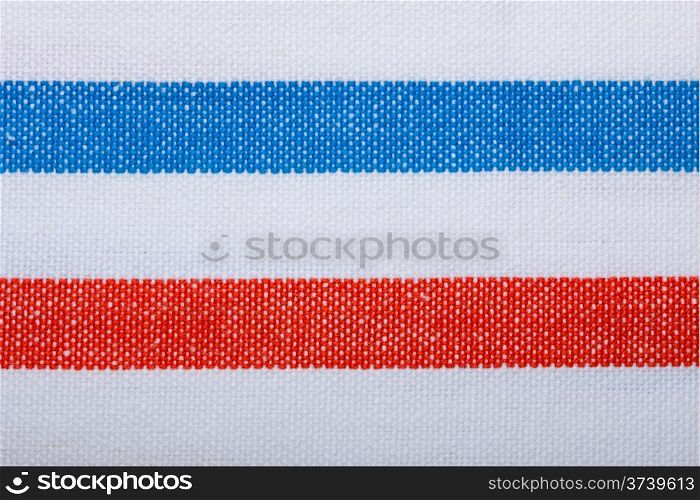 Closeup of blue red white horizontal striped fabric textile as background texture or pattern. Macro.