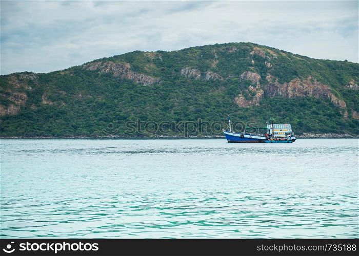 Closeup of boat on the beach with mountain island