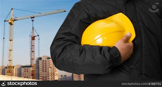 Closeup of builder with helmet on building background