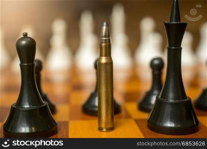 Closeup of bullet standing on place of queen chess piece