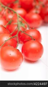 Closeup of Bunch of Fresh Cherry Tomatoes on White Table