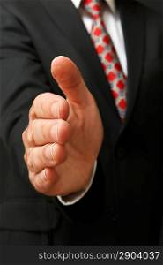 closeup of businessman&acute;s hand outstretched for a handshake