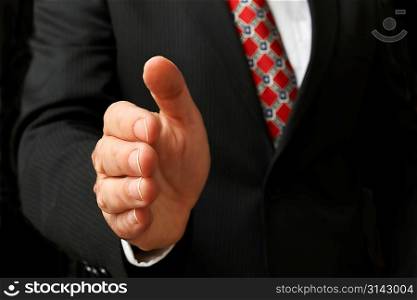 closeup of businessman&acute;s hand outstretched for a handshake