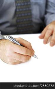 Closeup of businessman&acute;s hands on white background holding a pen