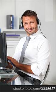 Closeup of businessman in the office with headphones