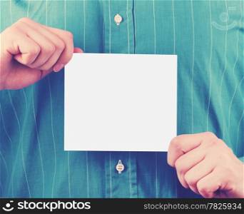 Closeup of businessman&rsquo;s hand holding up card