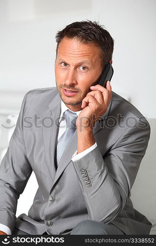 Closeup of businessman talking on mobile phone