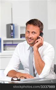 Closeup of businessman talking on the phone in the office