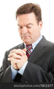 Closeup of businessman with his head bowed in prayer. White background.