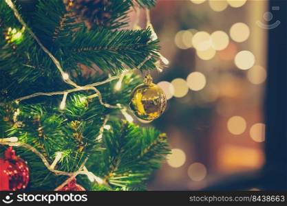 Closeup of christmas ball hanging from Christmas tree.