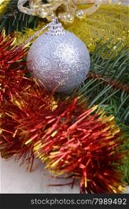 Closeup of Christmas balls and green fir tree branch, new year invitation card