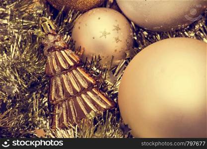 Closeup of Christmas-tree decorations, gold christmas background sparkles winter holiday. Closeup of Christmas-tree decorations, gold christmas background sparkles