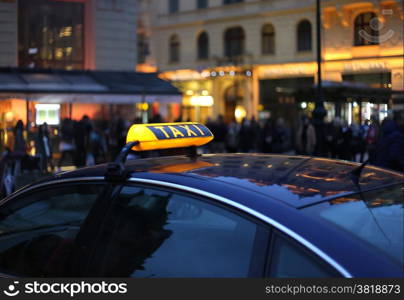 Closeup of city Taxi sign at night