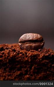 Closeup of coffee beans at the mixed heap of roasted coffee with copy space for text. Concept of Coffee freshness