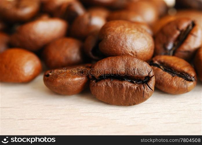 Closeup of coffee beans on a wooden table. Coffee beans