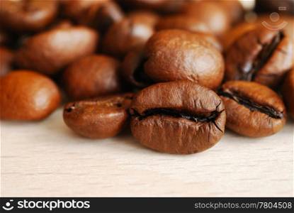 Closeup of coffee beans on a wooden table. Coffee beans