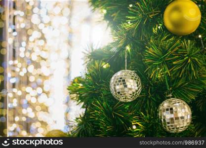 Closeup of Colorful balls on Green Christmas tree background Decoration During Christmas and New Year, bokeh lights