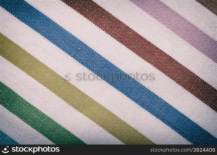 Closeup of colorful diagonal striped fabric textile as background texture or pattern. Macro.