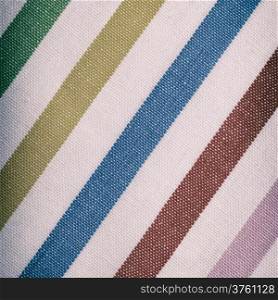 Closeup of colorful diagonal striped fabric textile as background texture or pattern. Macro. square format