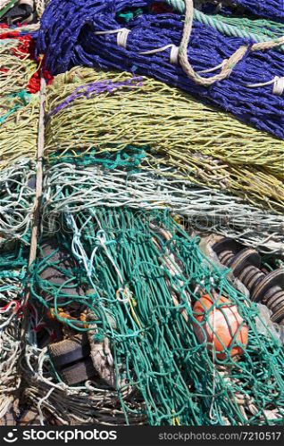 closeup of colorful fishing nets in harbor form an almost abstract pattern
