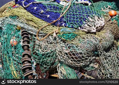 closeup of colorful fishing nets in harbor form an almost abstract pattern