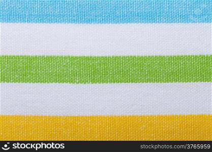 Closeup of colorful horizontal striped fabric textile as background texture or pattern. Macro.