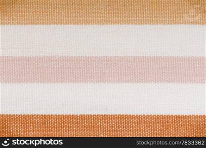 Closeup of colorful pink orange horizontal striped fabric textile as background texture or pattern. Macro.