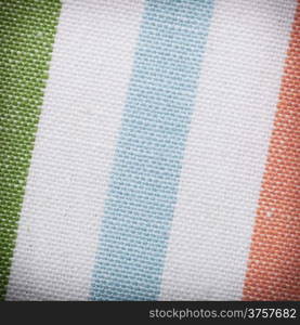 Closeup of colorful striped fabric textile as background texture or pattern. Macro.