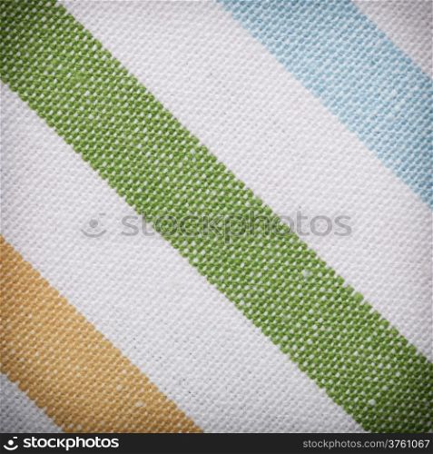 Closeup of colorful striped fabric textile as background texture or pattern. Macro.