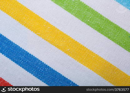 Closeup of colorful striped fabric textile as background texture or pattern. Macro.