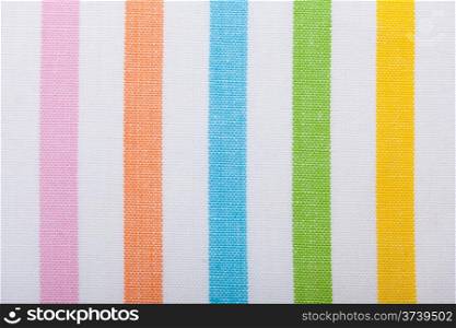 Closeup of colorful vertical striped fabric textile as background texture or pattern. Macro.