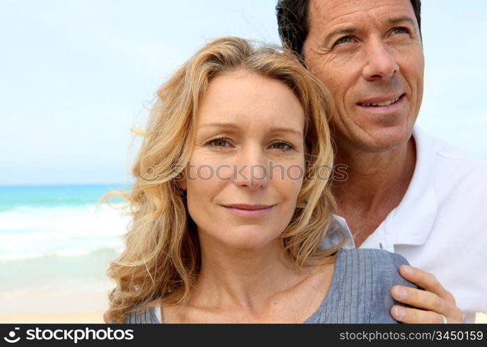 Closeup of couple on the beach, man looking to the sky