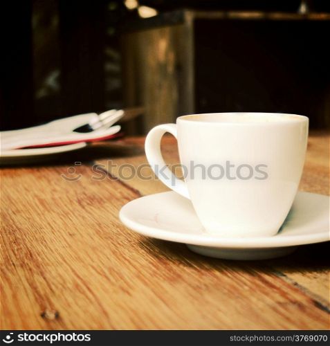 Closeup of cup of coffee on table at coffee shop