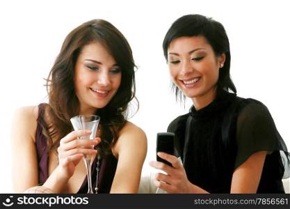 Closeup of cute young girls checking out their new mobilephone at home - Indoor