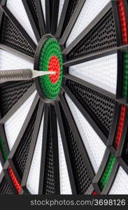 Closeup of dart board with dart.