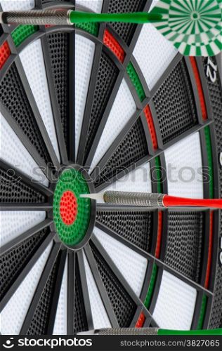 Closeup of dart board with darts.
