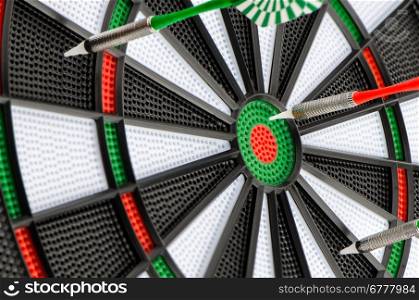Closeup of dart board with darts.