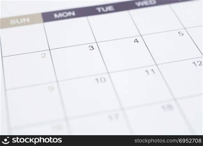 Closeup of dates on blank calendar page. Simple timetable planning for appointment schedule and business work management. Selective focus on background with vintage minimal style.