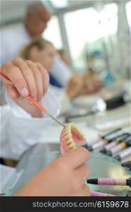 Closeup of dental technician working on dentures