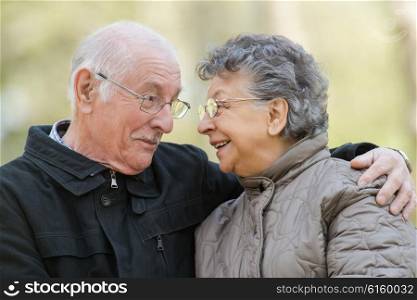 Closeup of elderly couple embracing