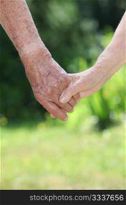 Closeup of elderly couple holding hands