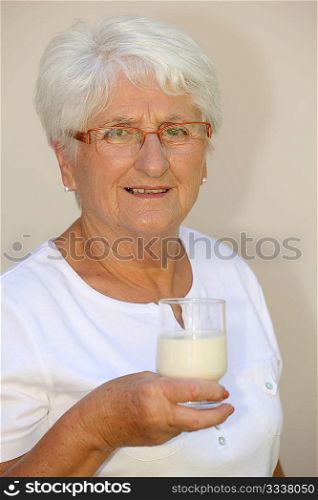 Closeup of elderly woman drinking milk from a glass