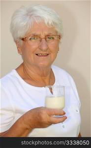 Closeup of elderly woman drinking milk from a glass