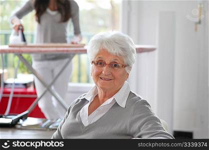 Closeup of elderly woman with home help