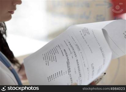 Closeup of female doctor hands holding test results of her patient