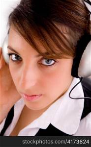 closeup of female entrepreneur listening music in headset with white background