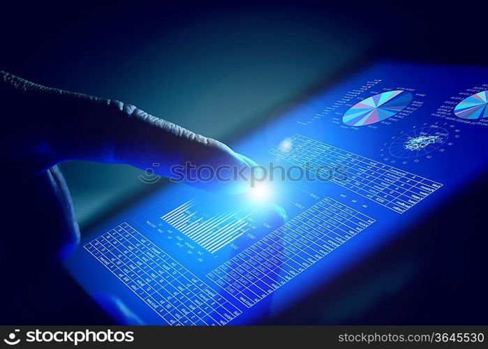 Closeup of finger touching blue toned screen on tablet-pc