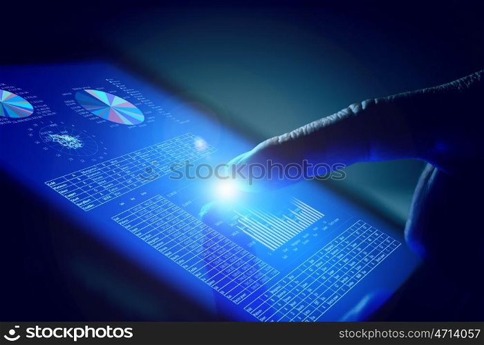 Closeup of finger touching tablet-pc screen. Closeup of finger touching blue toned screen on tablet-pc