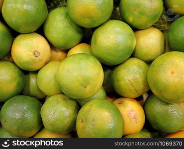 Closeup of fresh green oranges, delicious tropical fruit