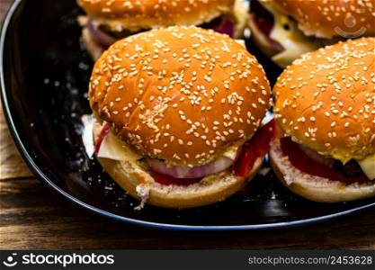 Closeup of fresh homemade tasty burgers on wooden table